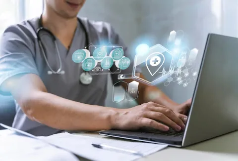 Doctor using laptop for healthcare IT and telemedicine solutions
